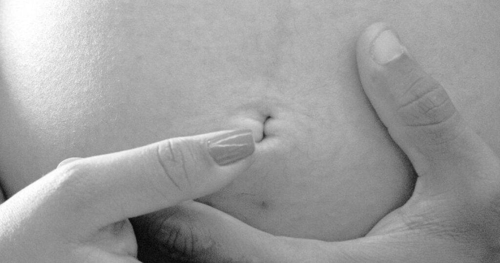 pregnant woman holding belly