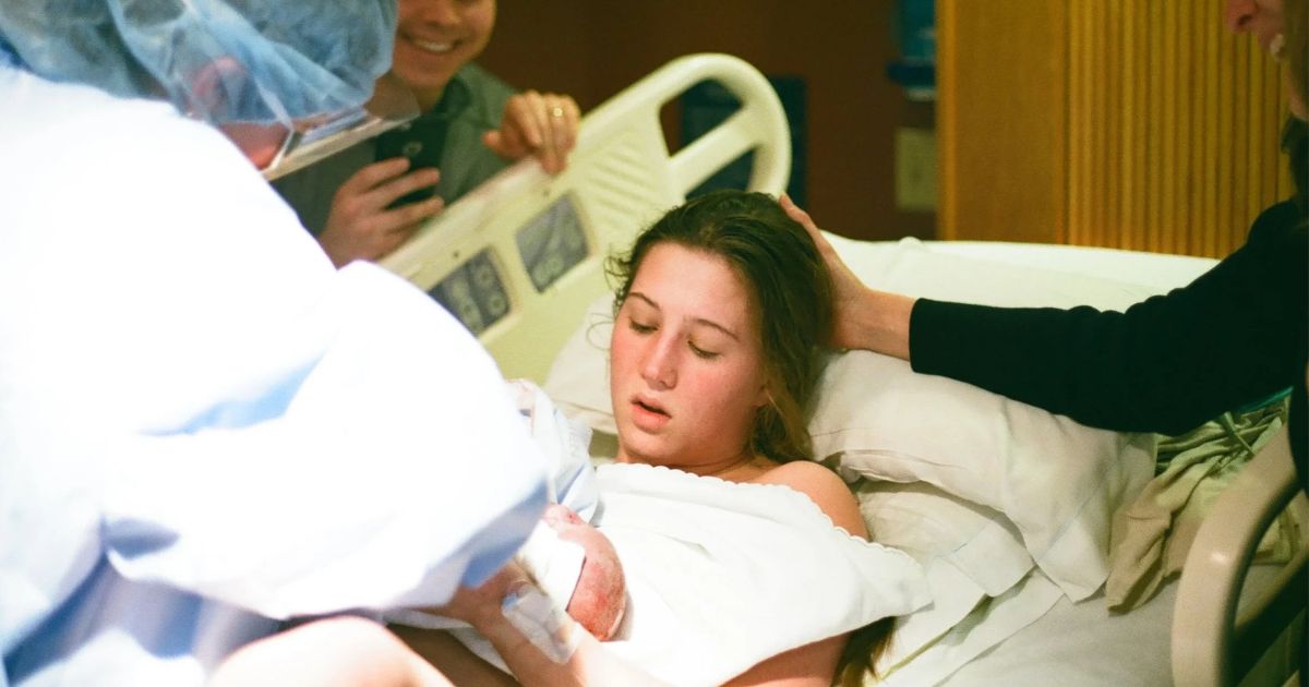 woman giving birth in the hospital with an OB