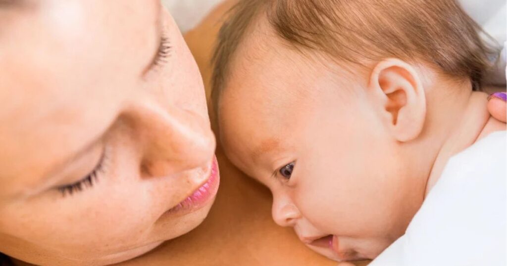 mom holding baby on chest