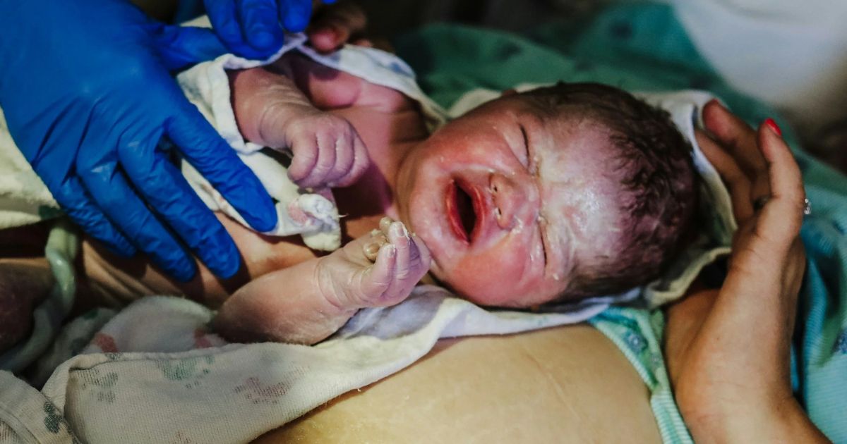 newborn baby at birth in the golden hour
