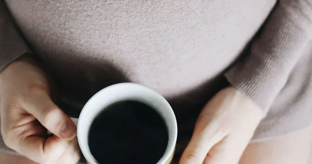 pregnant mom holding coffee