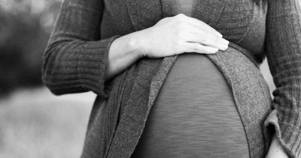 pregnant woman holding belly