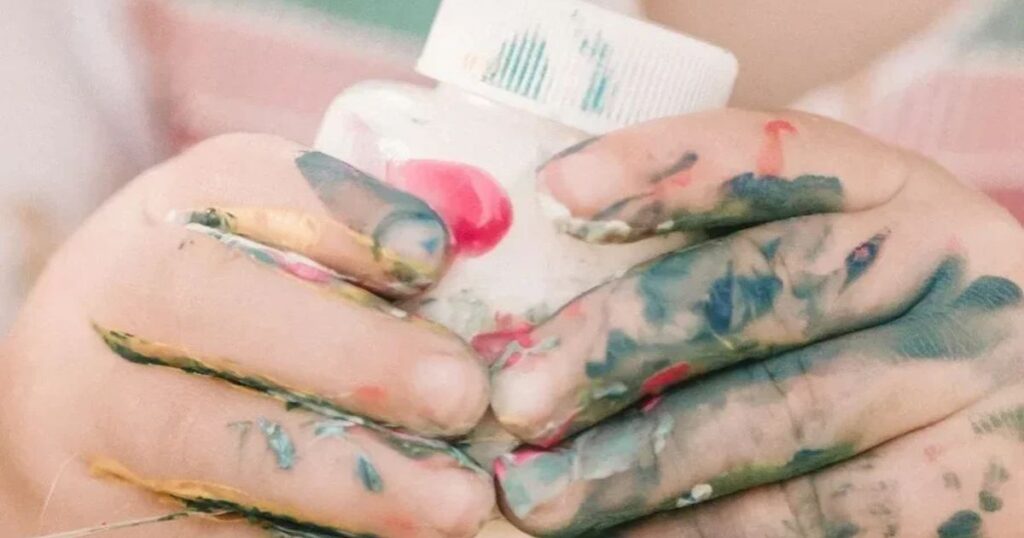toddler with paints