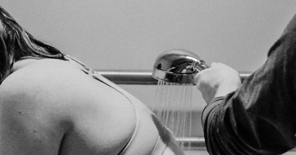 woman wearing bra in labor shower at hospital