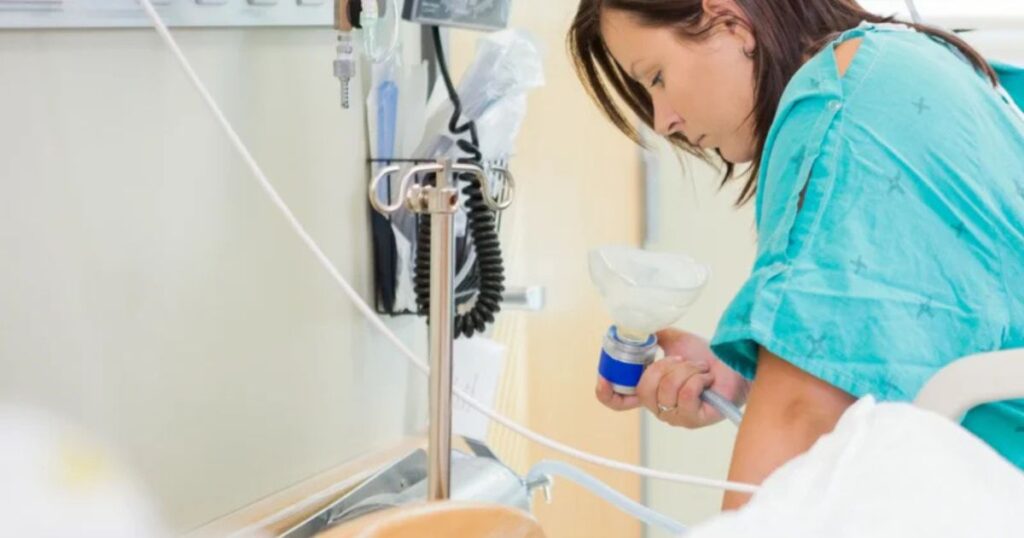 woman in labor with nitrous oxide at hospital