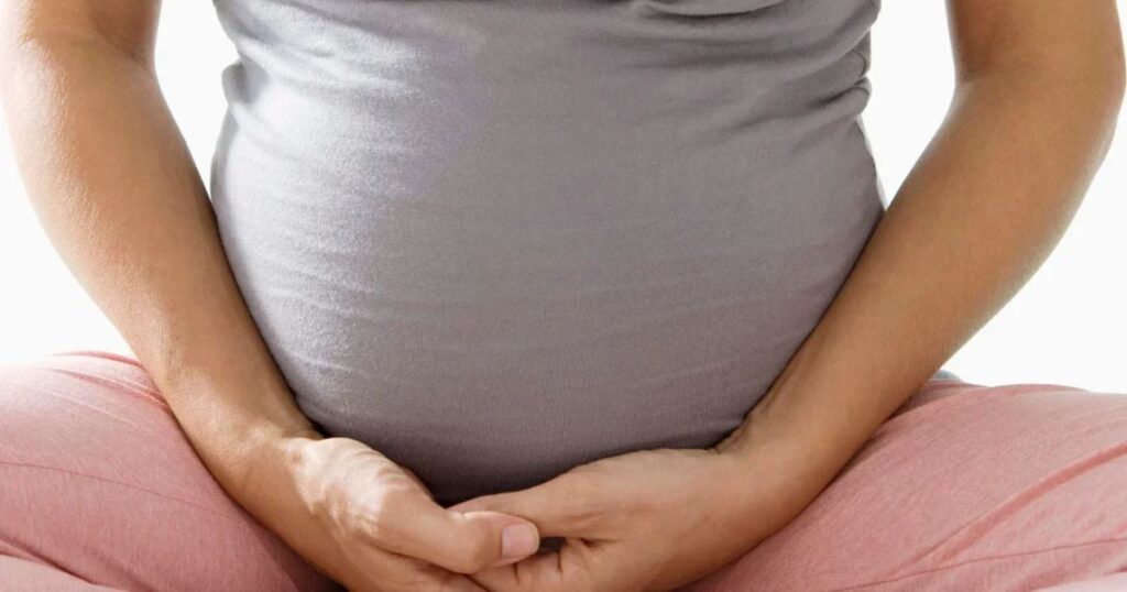 pregnant woman holding belly