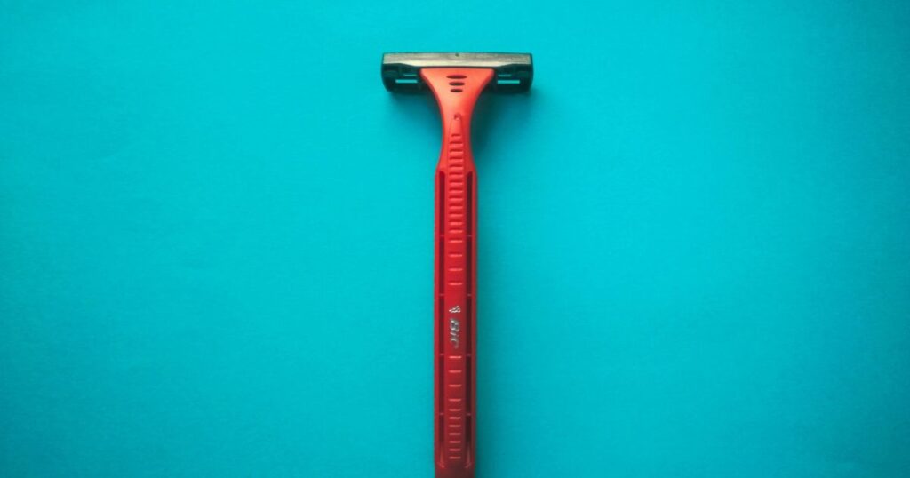 shaving razor on blue background