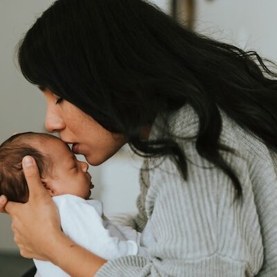 mom kissing baby